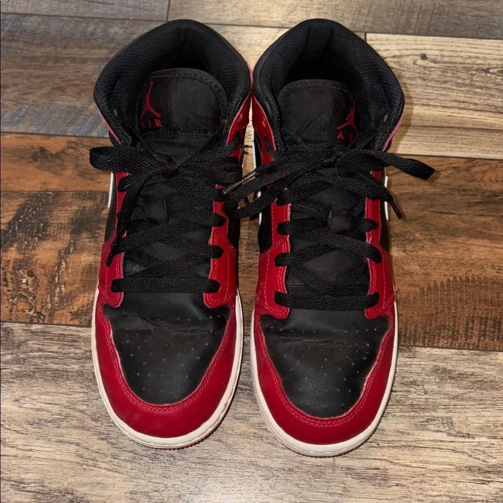 Nike Air Jordan 1 Mid in the black, white, and Gym Red
